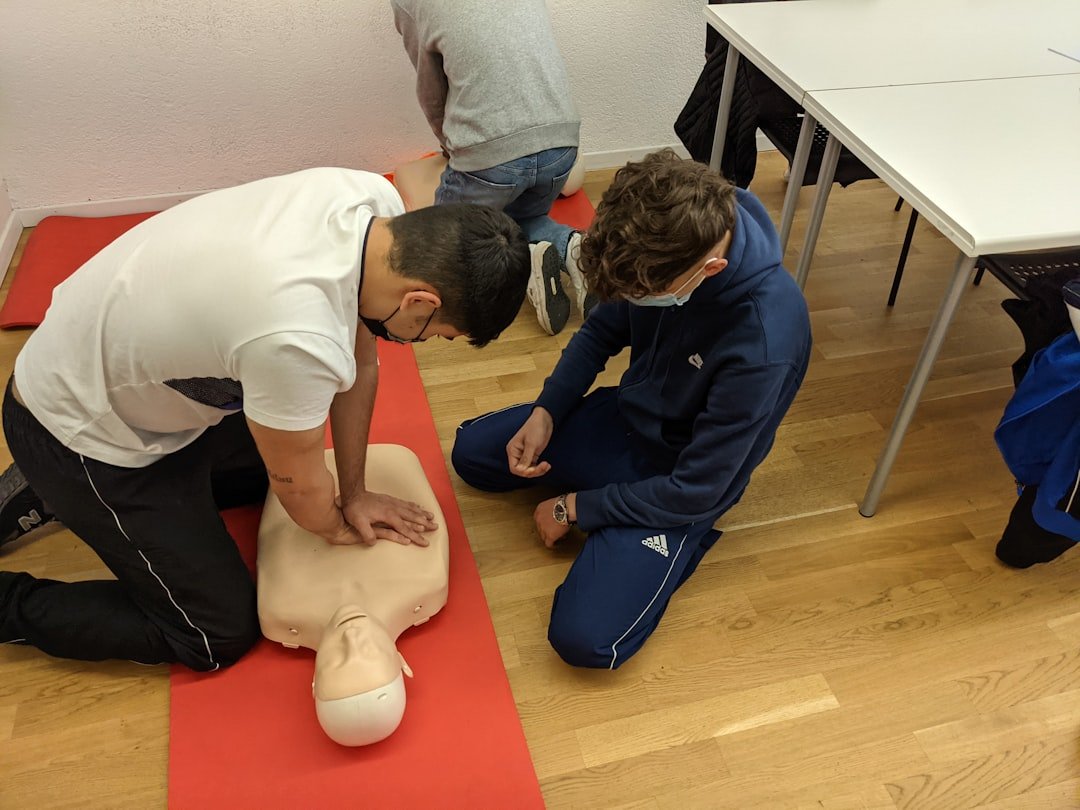 Instructor-led CPR skills station: participants practicing chest compressions on manikins during a GoMedTrng class